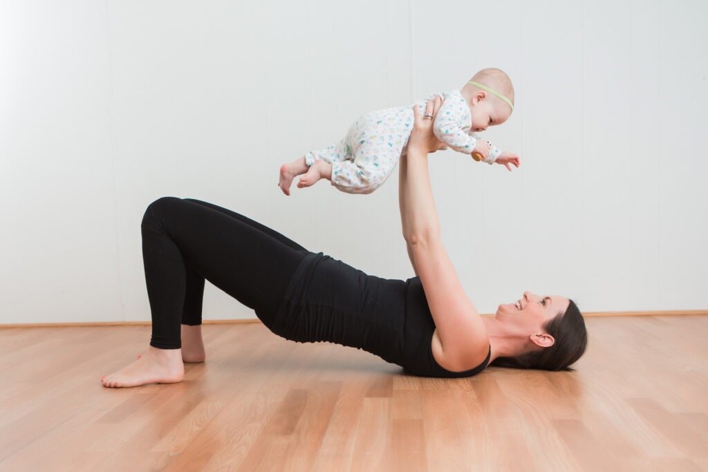 New mama exercises with her baby.